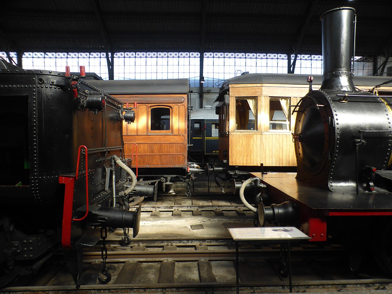 Locomotoras de vapor y vagones clásicos de madera en el interior del Museo del Ferrocarril de Madrid